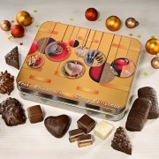 Gingerbread tin with Christmas ornaments, surrounded by gingerbread confectionery Gingerbread tin with Christmas ornaments, surrounded by gingerbread confectionery