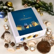 Open gift box with gingerbread tin, cookies, and assorted Christmas baked goods Open gift box with gingerbread tin, cookies, and assorted Christmas baked goods