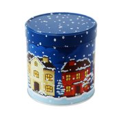 Closed gingerbread tin with a winter village design Closed gingerbread tin with a winter village design