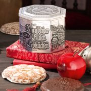 Silver tin on books, surrounded by Nuremberg Elisen gingerbread cookies Silver tin on books, surrounded by Nuremberg Elisen gingerbread cookies
